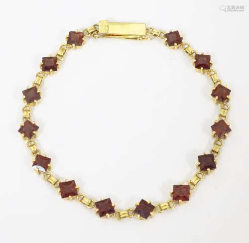 A 14ct gold bracelet set with garnets ( matching …
