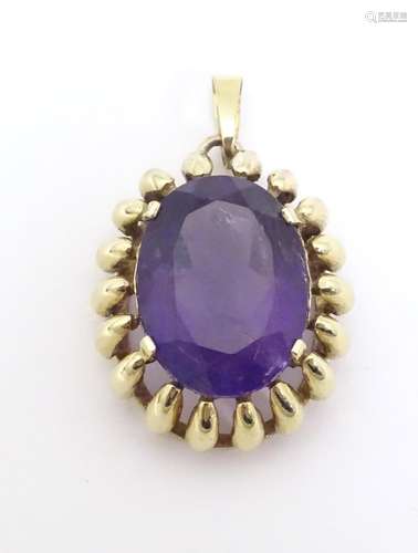 A 9ct gold pendant set with large amethyst. Approx…