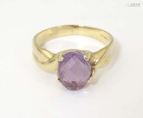 A 9ct gold ring set with oval facet cut amethyst. …