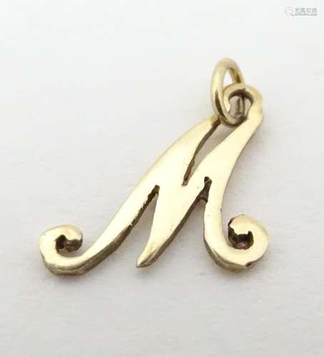 A 9ct gold pendant charm formed as the letter ' M …