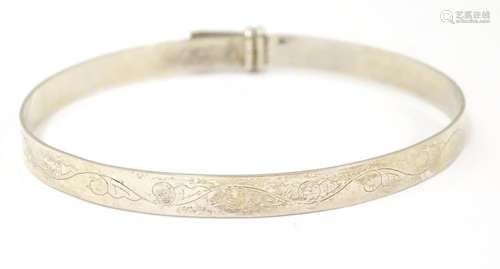 A silver bracelet of bangle form. hallmarked Birmi…