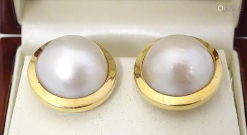 18ct gold earrings set with central pearls. Approx…