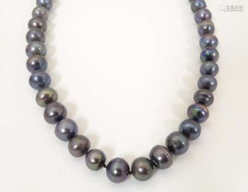 A long black pearl necklace approx. 52" long …