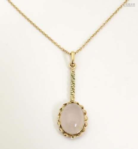 A pendant necklace set with rose quartz cabochon o…