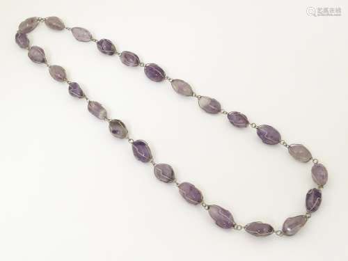 An Amethyst necklace set with white metal mounts .…