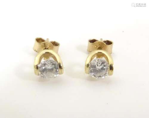 A pair of 9ct gold earrings set with white stone d…