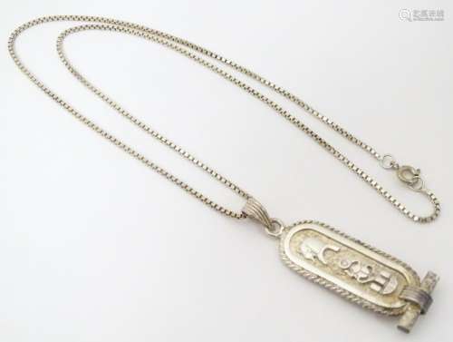 An Egyptian silver pendant and chain, the pendant …