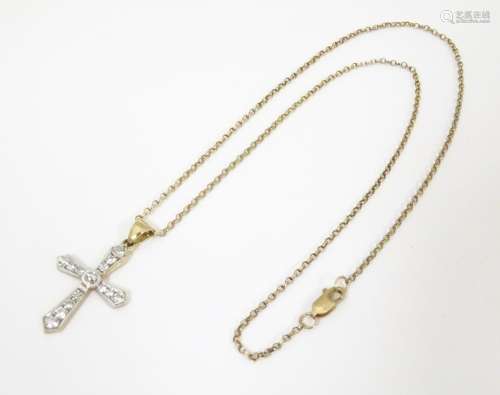 A 9ct gold crucifix pendant set with white stones …