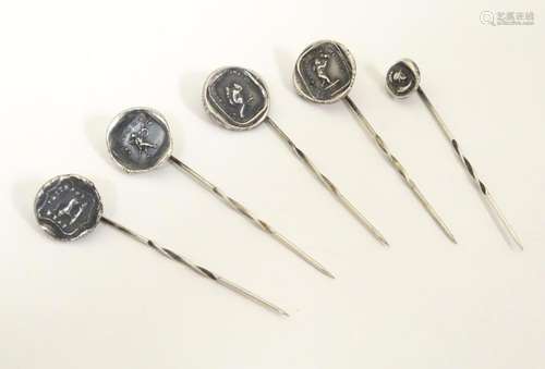 Five various white metal stick pins surmounted by …