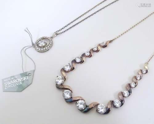 Two silver / white metal necklaces to include one …