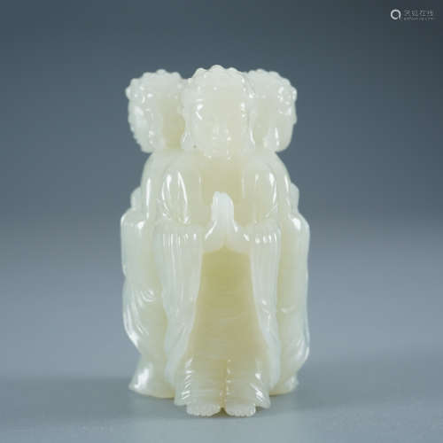 A Carved White Jade Three-Faced Buddha