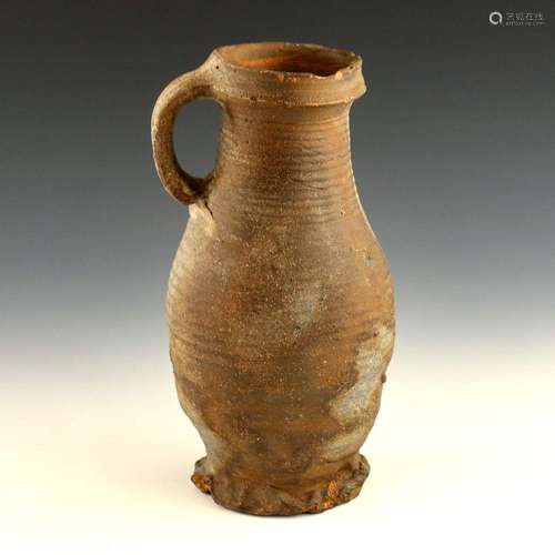 A 14th century earthenware baluster jug,