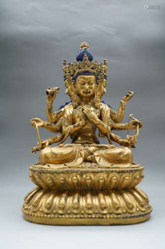 A Gilt Bronze  Buddha With Four Arms Seating Statue