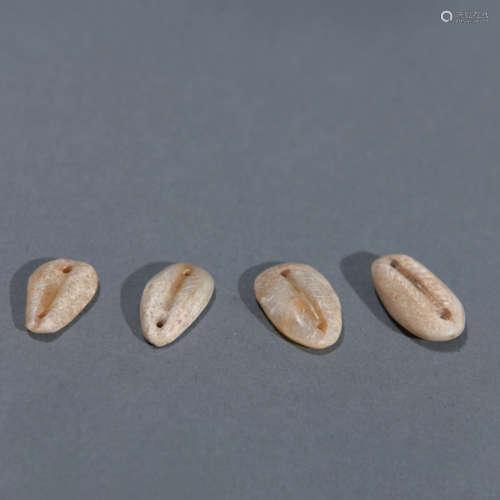 Four Carved Jade Shell Coins