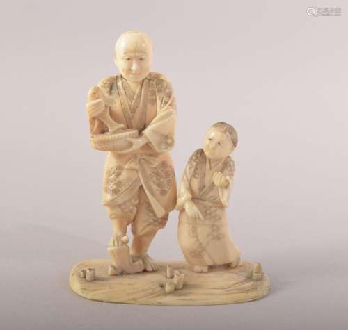 A JAPANESE CARVED IVORY FIGURE OF MAN WITH FISH and a boy at...