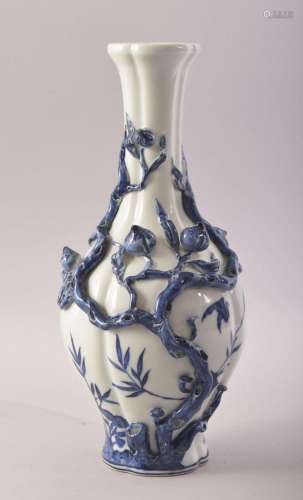 A CHINESE BLUE AND WHITE PORCELAIN VASE, with moulded relief...