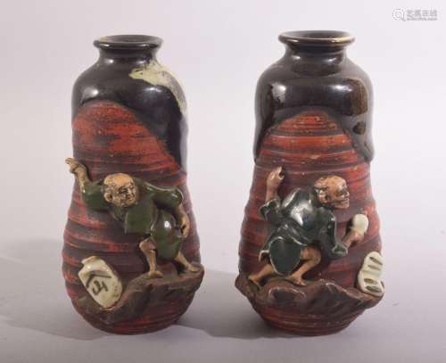 AN UNUSUAL PAIR OF SMALL JAPANESE FIGURAL POTTERY VASES, the...