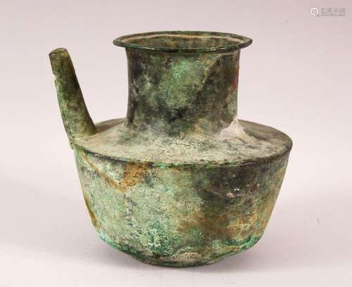 AN EARLY ISLAMIC BRONZE JUG, 14.5cm high.