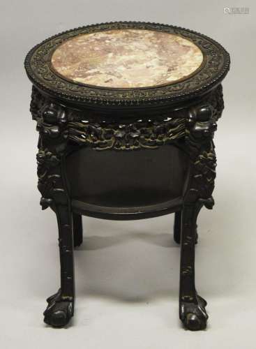 A CHINESE CARVED HARDWOOD MARBLE TOP TWO TIER STAND, the fri...