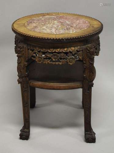 A CHINESE CARVED HARDWOOD MARBLE TOP STAND, the frieze and l...