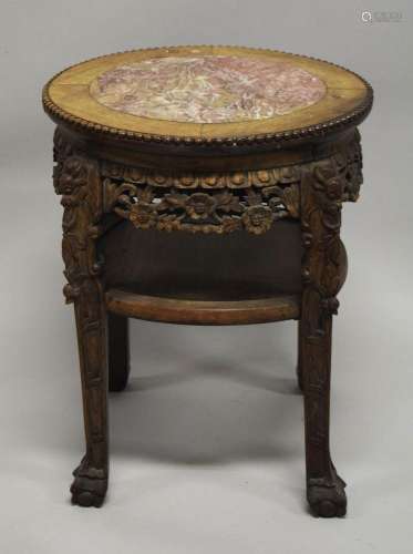 A CHINESE CARVED HARDWOOD MARBLE TOP STAND, the frieze and l...