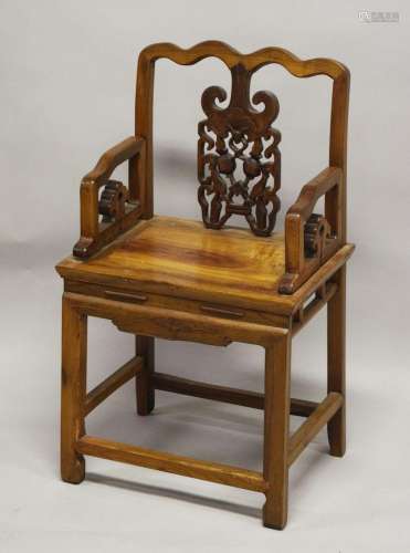 A CHINESE PIERCED AND CARVED WOODEN CHAIR, with shaped top r...
