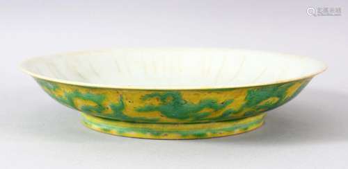 A CHINESE YELLOW GROUND PORCELAIN DRAGON DISH, the base with...