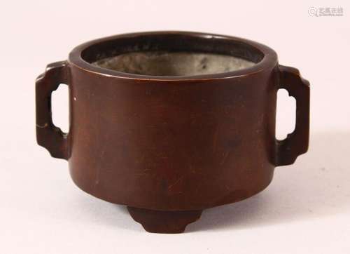 A CHINESE BRONZE TWIN HANDLED CENSER, on three feet with an ...