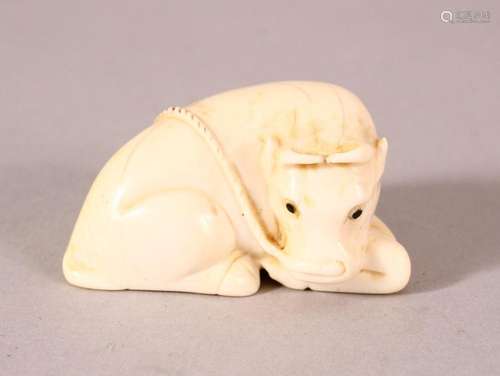 A JAPANESE MEIJI PERIOD CARVED IVORY NETSUKE OF A RECUMBENT ...