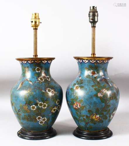 A PAIR OF CHINESE BLUE GROUND CLOISONNE VASES / LAMPS, decor...