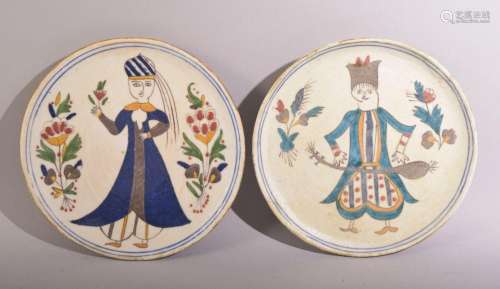 A PAIR OF TURKISH KUTAHYA PLATES, painted with a male and fe...