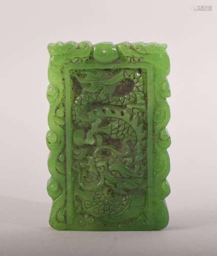 A CHINESE CARVED JADEITE PENDANT, carved with dragon to one ...