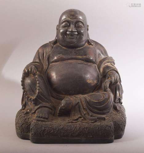 A CHINESE BRONZE SEATED BUDDHA, with faint traces of red and...