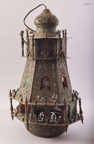 A PERSIAN QAJAR BRASS OPENWORK HANGING LANTERN, with stained...