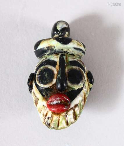 A SMALL SYRIAN GLASS PENDANT, in the form of a bearded male ...