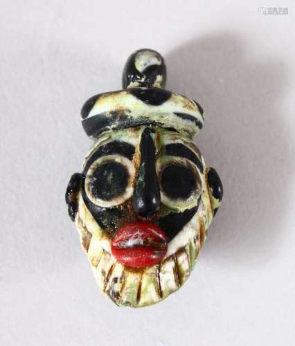 A SMALL SYRIAN GLASS PENDANT, in the form of a bearded male ...