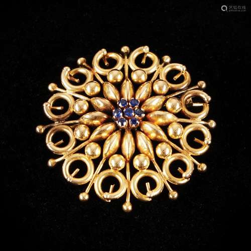 A 18kt. gold round brooch with sapphires