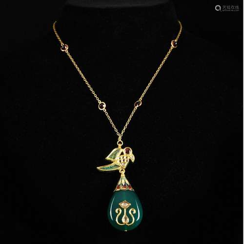 A 18kt. gold parrot pendant with enamel, emeralds, rubies an...