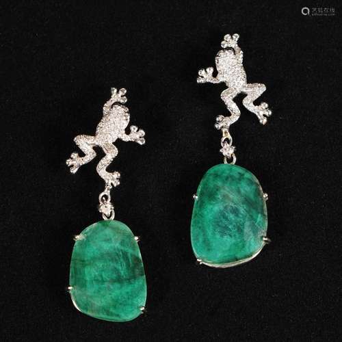 A pair of 18kt. gold frog earrings with diamonds and emerald...