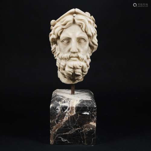 a white marble head of a bearded man
