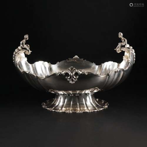 A chiseled silver oval centerpiece