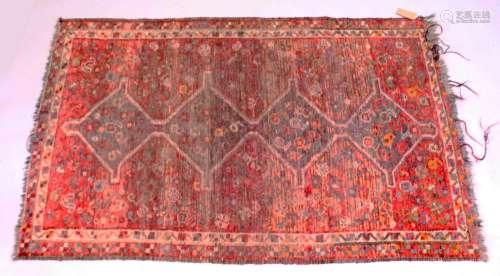 A PESIAN TEKKE DESIGN RUG, red ground with four large centra...