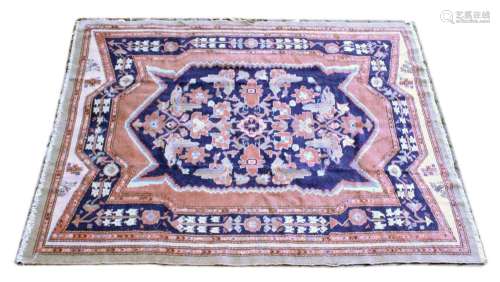 A PERSIAN CARPET, dark blue ground with stylised decoration,...