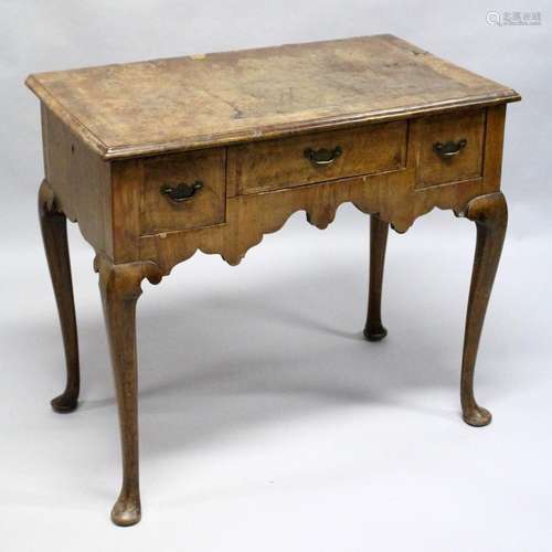 AN 18TH CENTURY WALNUT LOW BOY, with a crossbanded top, thre...