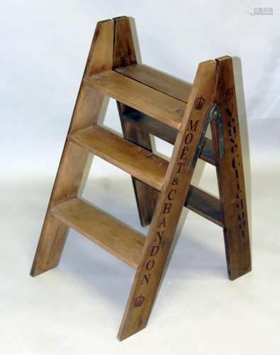 A WOODEN CHAMPAGNE FOLDING LADDER 2ft 8ins.