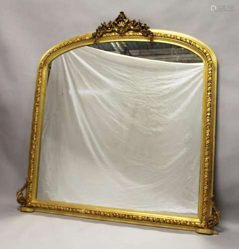 A LARGE GILTWOOD OVERMANTLE MIRROR with domed top, shell and...