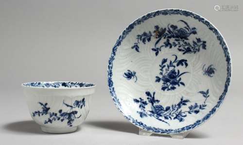 AN 18TH CENTURY WORCESTER TEA BOWL AND SAUCER painted with h...