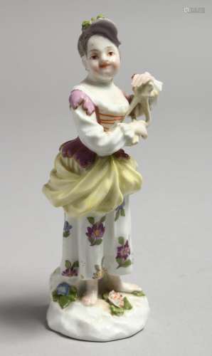 A MID 18TH CENTURY MEISSEN FIGURE OF A YOUNG WOMAN PLAYING A...