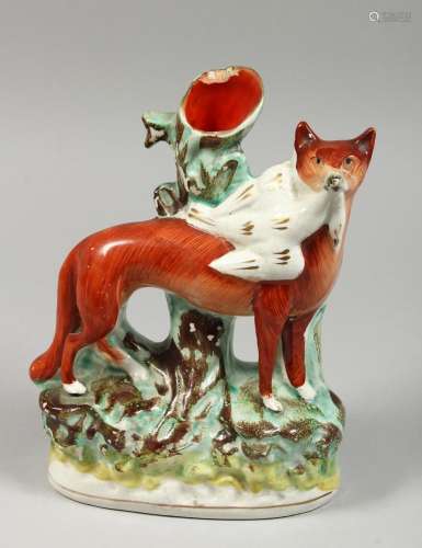 A STAFFORDSHIRE SPILL VASE with a figure of a fox with a bir...