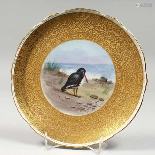 A MINTON PLATE, rich gilt border, the centre painted with a ...